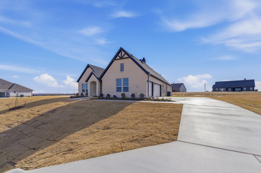 Front exterior of a new home in Eagle Ridge Estates, Weatherford, TX, highlighting curb appeal (Image 18).