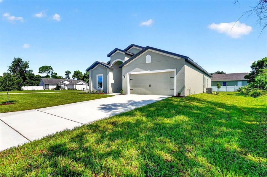 Front exterior of a new home in , Deltona, FL, highlighting curb appeal (Image 20). Front exterior of a new home in , Deltona, FL, highlighting curb appeal (Image 20).