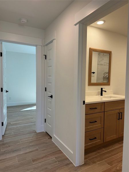 Hall featuring wood finish floors and baseboards
