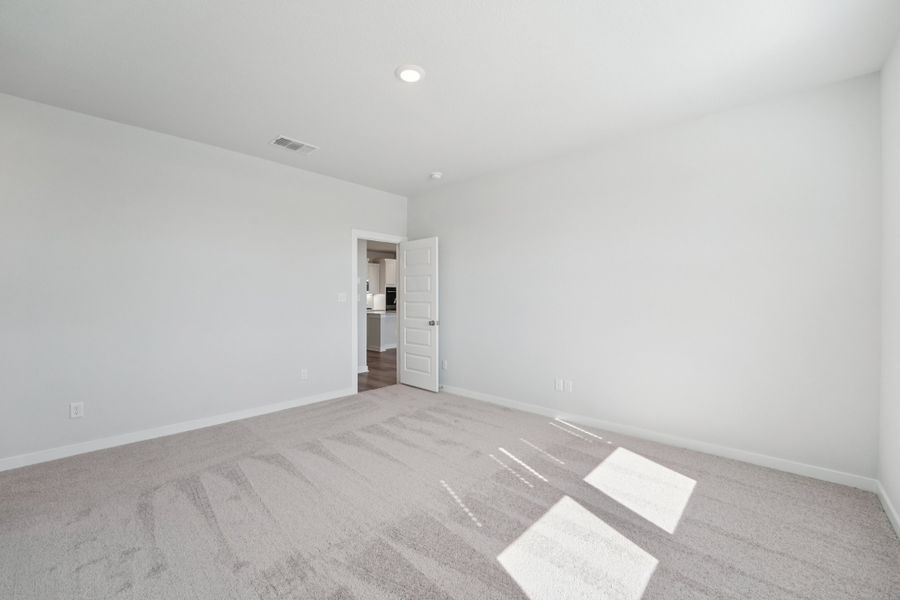 A room with a carpet and a door.