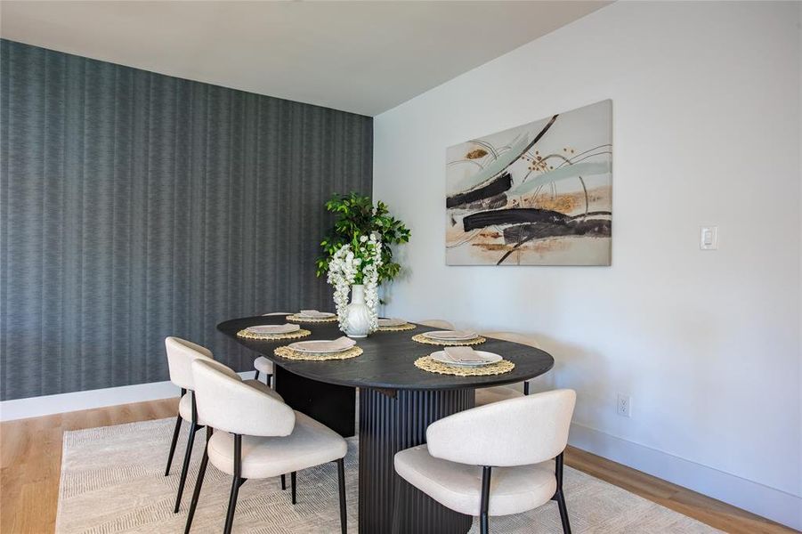 Dining space with hardwood / wood-style flooring