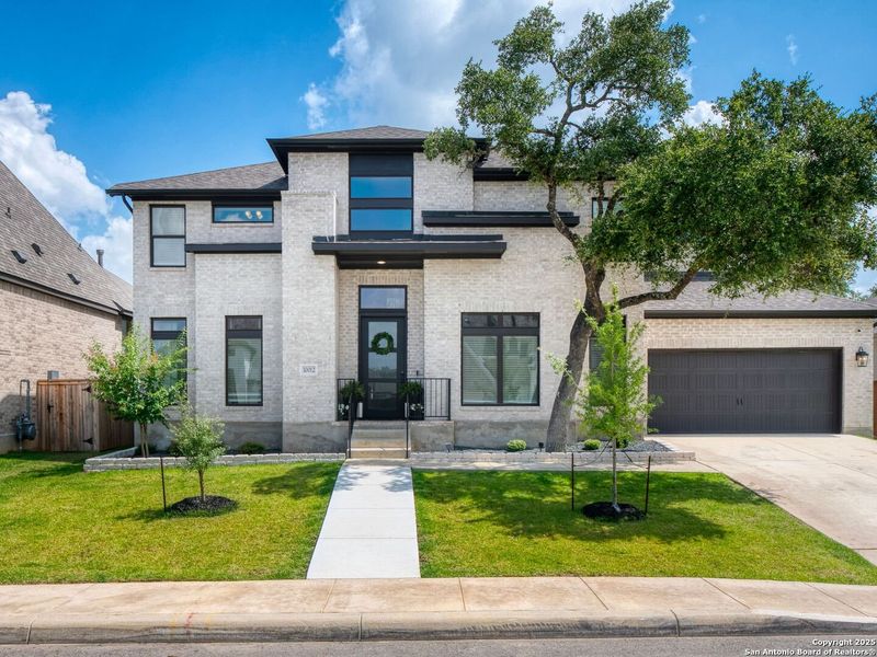 Front exterior of a new home in Balcones Creek 70', Boerne, TX, highlighting curb appeal (Image 20). Front exterior of a new home in Balcones Creek 70', Boerne, TX, highlighting curb appeal (Image 20).