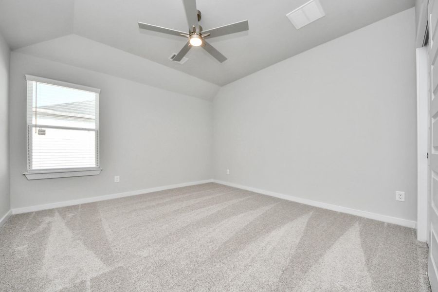 Secondary bedroom features plush carpeting, large windows that let in plenty of natural light, bright paint, and spacious closets.