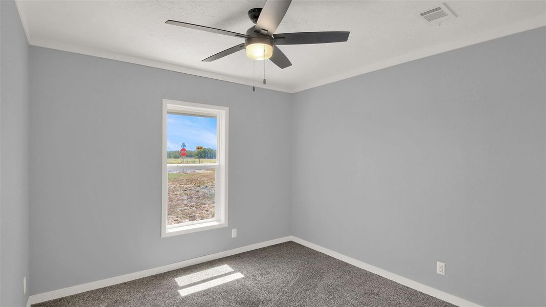 Crown molding and plush carpeting define this versatile secondary space.