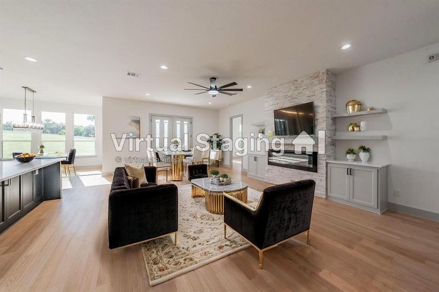 Living area with light wood-style floors, a ceiling fan, and recessed lighting