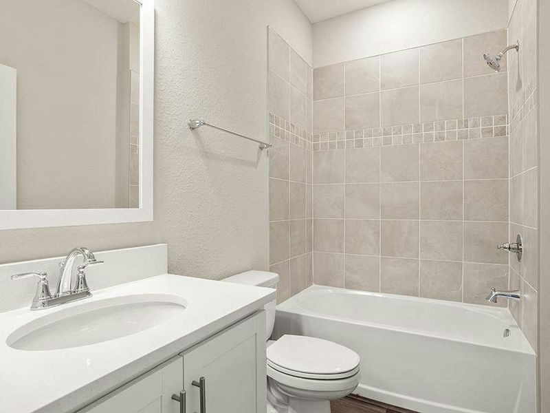 Secondary bedrooms share a hall bath, and a powder room is available for your guests.