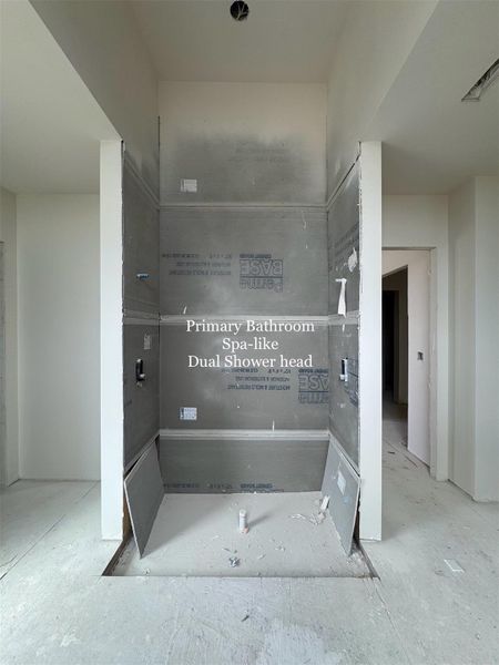 Luxurious spa-inspired Wet Room with Dual Shower-heads and space for a Freestanding Soaking Tub across, creating a serene retreat within the primary suite.