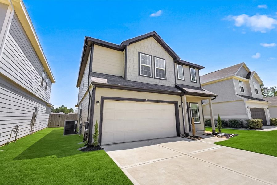 Front exterior of a new home in River's Edge, Conroe, TX, highlighting curb appeal (Image 1). Front exterior of a new home in River's Edge, Conroe, TX, highlighting curb appeal (Image 1).