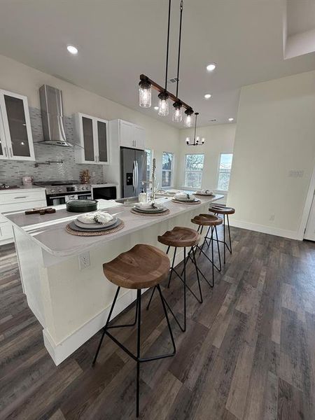 Closer view for kitchen island, quartz white countertiops, and stainless steel appliance package.