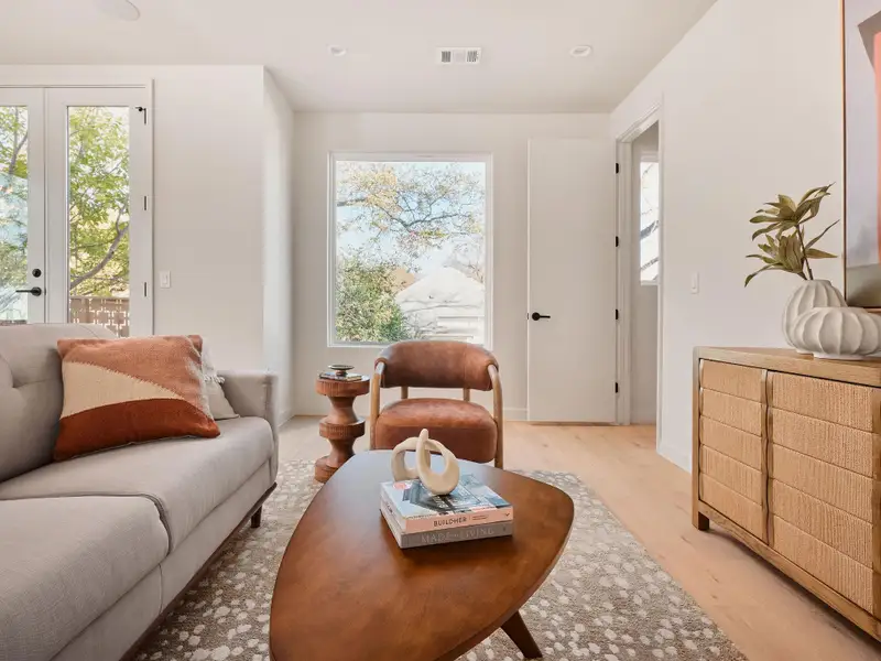 Living area with healthy amount of natural light, french doors, and wood finished floors