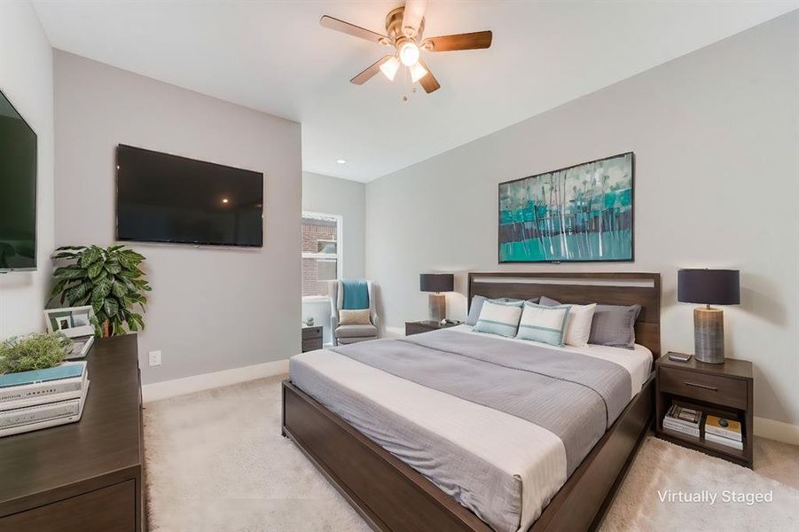 Carpeted bedroom featuring ceiling fan