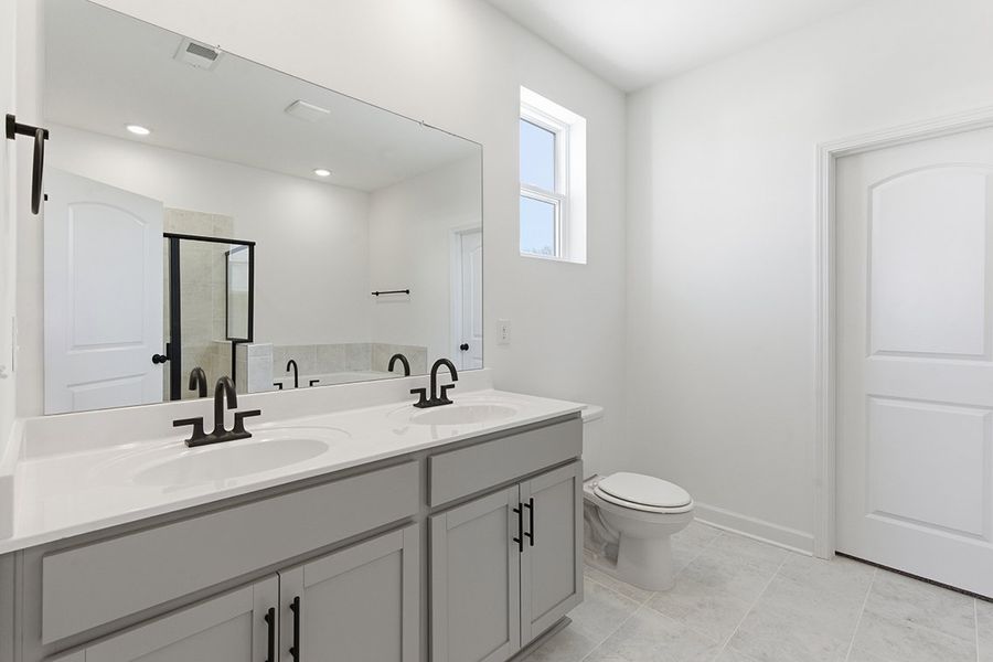 A bathroom with a large mirror.