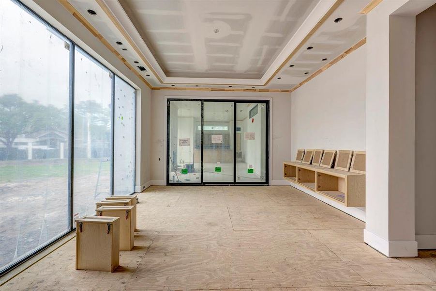 Large dining room with built-in storage has views of the pool area and access to the outdoor living room with summer kitchen. Stage of construction as of April 3, 2025. Large dining room with built-in storage has views of the pool area and access to the outdoor living room with summer kitchen. Stage of construction as of April 3, 2025.