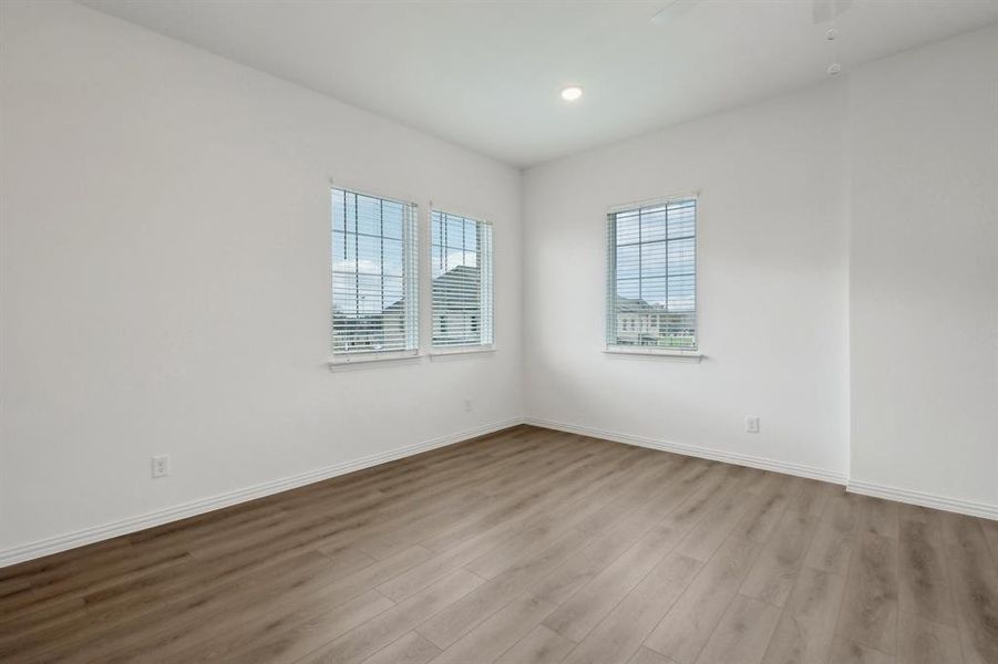 Spare room featuring ceiling fan and light hardwood / wood-style flooring