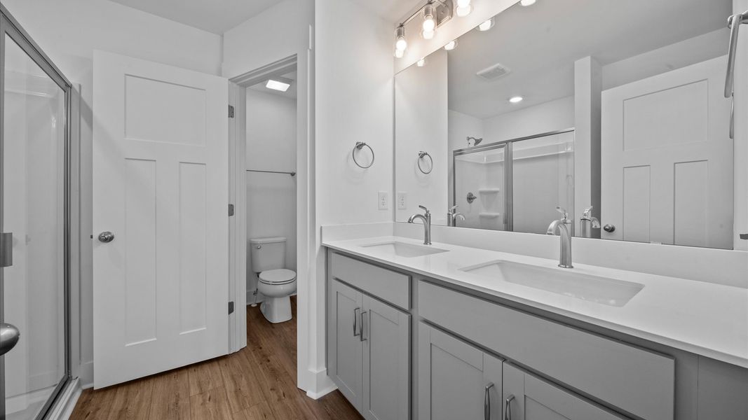 Spacious primary bathroom with double sink vanity in two story townhome at Ransdell Pointe by DRB Homes in Spartanburg, SC