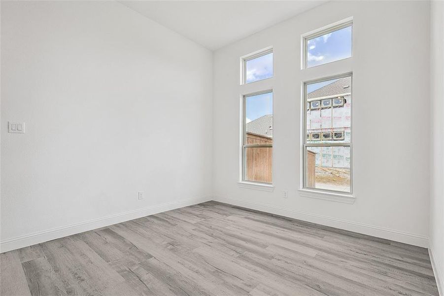 Spare room with plenty of natural light and light hardwood / wood-style flooring