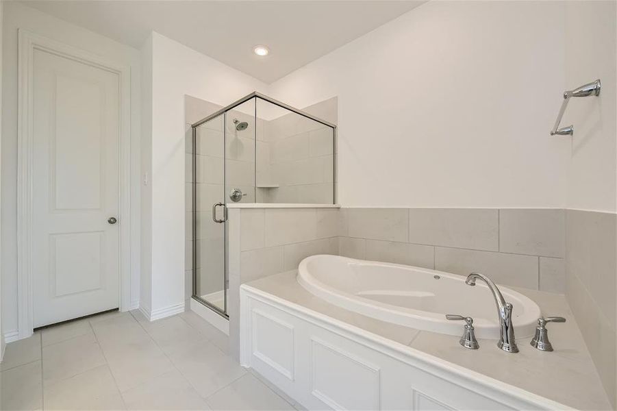 Bathroom featuring independent shower and bath and tile floors