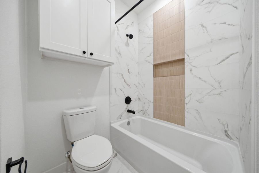Tub/shower combo with beautiful tile detail. Tub/shower combo with beautiful tile detail.