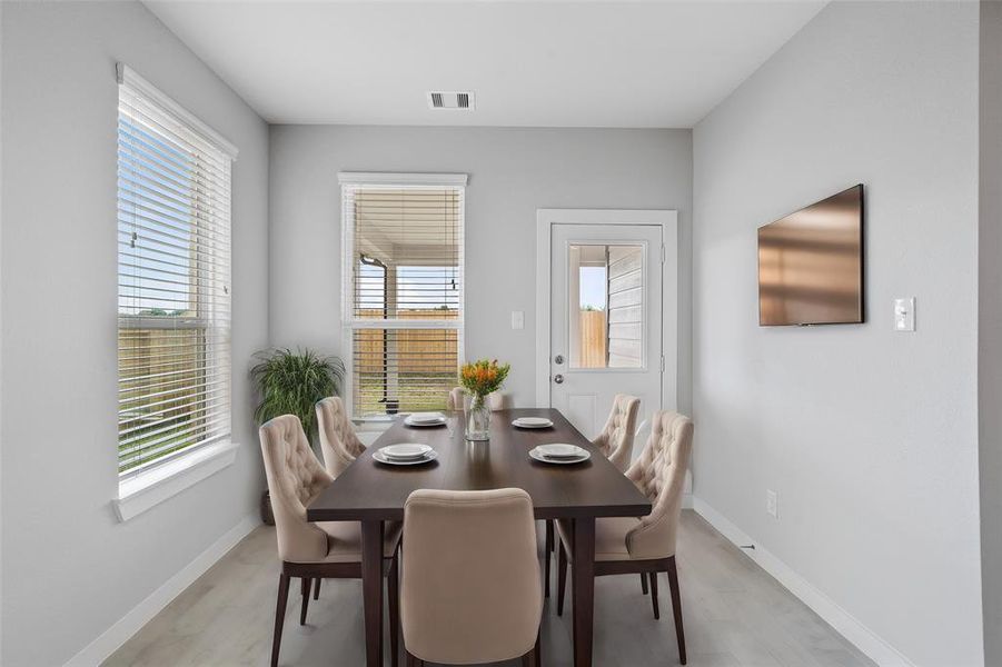 Start your day off right with a cup of coffee sitting with your family in the lovely breakfast area! Featuring large windows with blinds, custom neutral paint, tile flooring, recessed lighting and high ceilings!