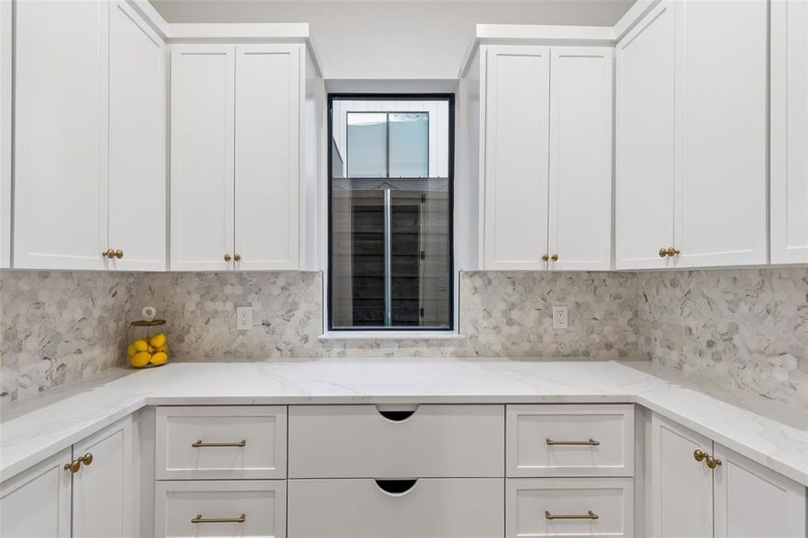 Spacious walk-in pantry with custom cabinetry, abundant storage, and convenient prep space.