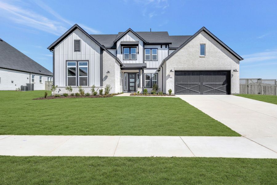 Front exterior of a new home in Pecan Square - Estates, Northlake, TX, highlighting curb appeal (Image 1). Front exterior of a new home in Pecan Square - Estates, Northlake, TX, highlighting curb appeal (Image 1).