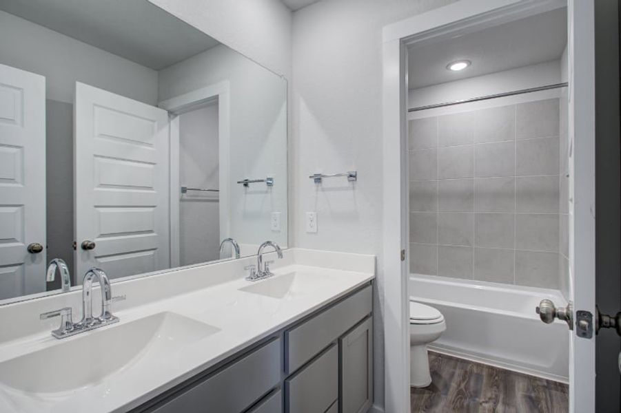 A bathroom with a sink and a toilet. A bathroom with a sink and a toilet.