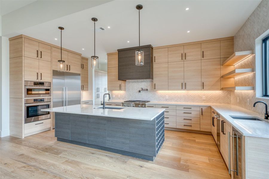 Gourmet kitchen has custom cabinets, quartz countertops, wine storage, and a large island. Premium appliance package: Thermador gas range, Bosch built in column refrigerator/freezer