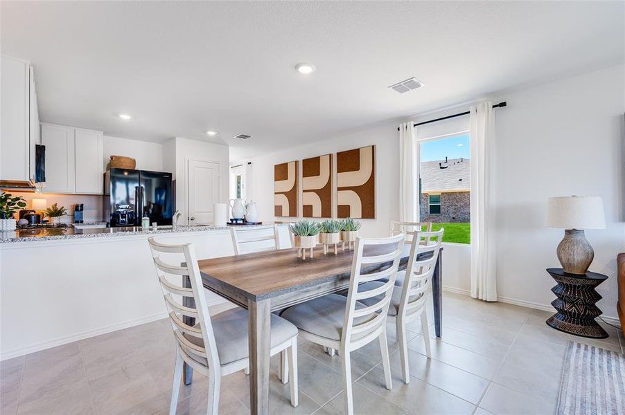 Dining area with light tile patterned flooring