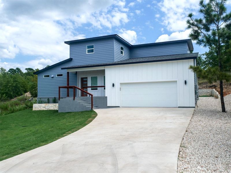 Modern architectural residence featuring a two-tone facade with horizontal siding and vertical paneling