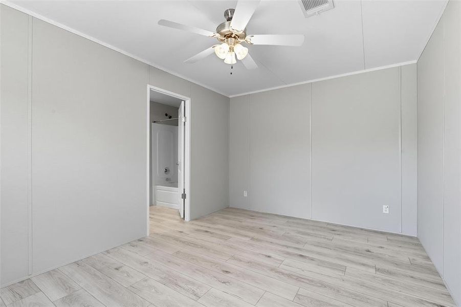 Spare room featuring light wood-type flooring, crown molding, and ceiling fan Spare room featuring light wood-type flooring, crown molding, and ceiling fan