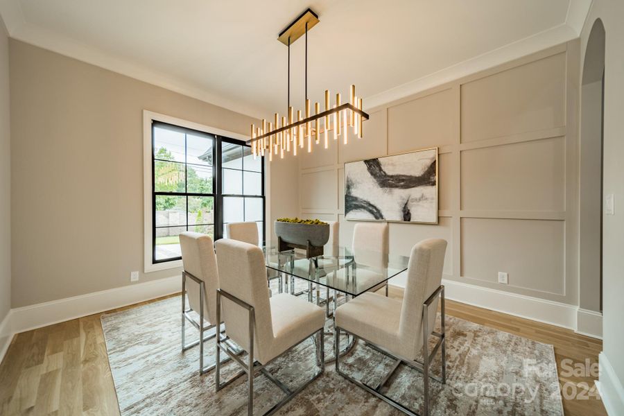 Dining room with desginer chandelier and board & batten wall detail