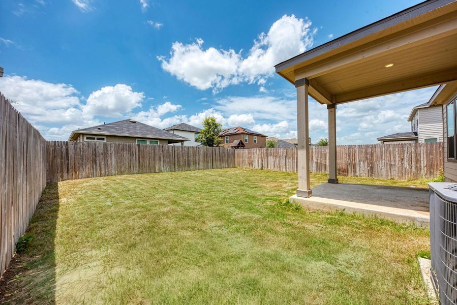 A spacious backyard awaits, featuring a covered patio for outdoor enjoyment.