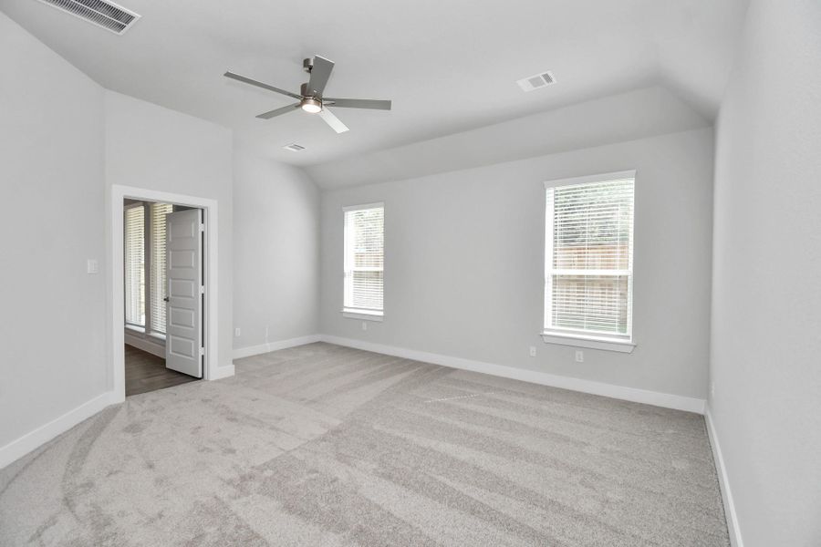 Come and unwind after a long day in this magnificent primary suite! This spacious room features plush carpet, warm paint, high ceilings and large windows with privacy blinds. Sample photo of completed home with similar floor plan. Actual colors and selections may vary. Come and unwind after a long day in this magnificent primary suite! This spacious room features plush carpet, warm paint, high ceilings and large windows with privacy blinds. Sample photo of completed home with similar floor plan. Actual colors and selections may vary.