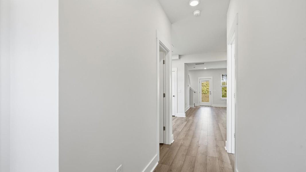 Refined foyer with hardwood floors and thoughtful design for a first-rate welcome