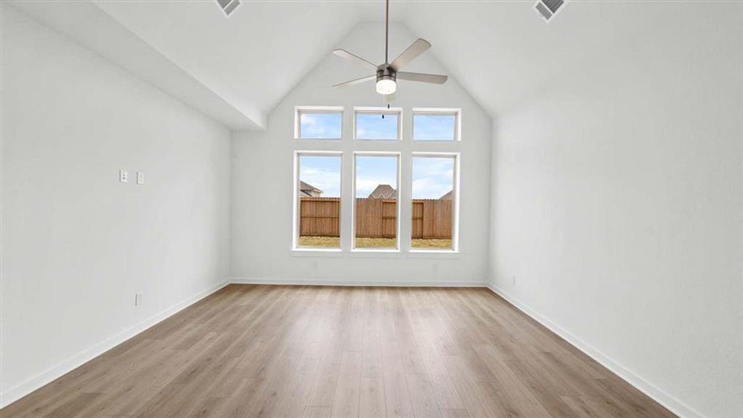 Family room with Vaulted ceiling and views of the backyard