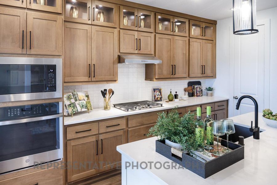 Kitchen with appliances with stainless steel finishes, decorative backsplash, light countertops, and brown cabinets