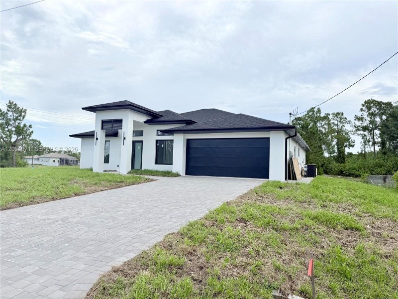 Front exterior of a new home in , Lehigh Acres, FL, highlighting curb appeal (Image 21).