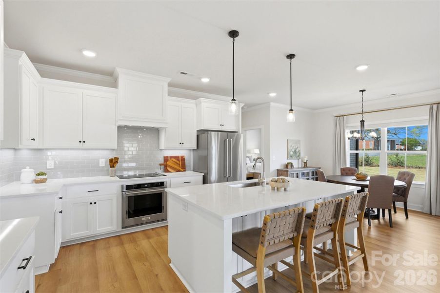 Bright and functional layout with ample cabinetry and seamless connection to the dining area.
