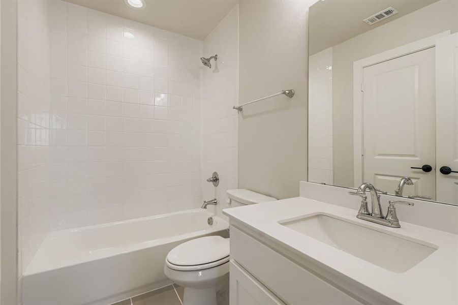 Bathroom with vanity, bathing tub / shower combination, and tile patterned floors