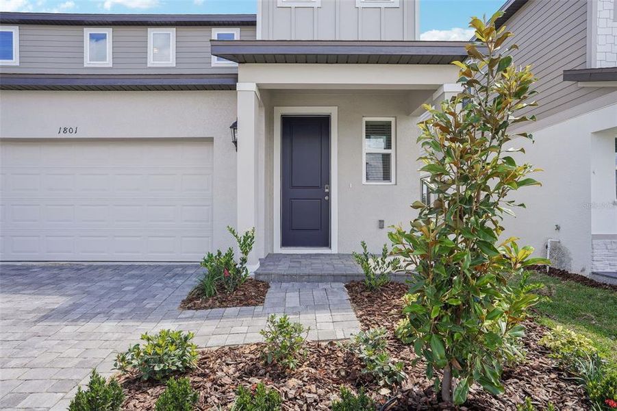 Front exterior of a new home in Cyrene at Minneola - Villas, Montverde, FL, highlighting curb appeal (Image 17). Front exterior of a new home in Cyrene at Minneola - Villas, Montverde, FL, highlighting curb appeal (Image 17).