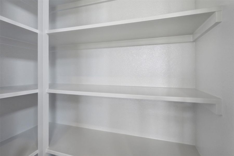 Generous walk in pantry offering abundant shelving and storage space, making organization simple and keeping your kitchen clutter free. Generous walk in pantry offering abundant shelving and storage space, making organization simple and keeping your kitchen clutter free.