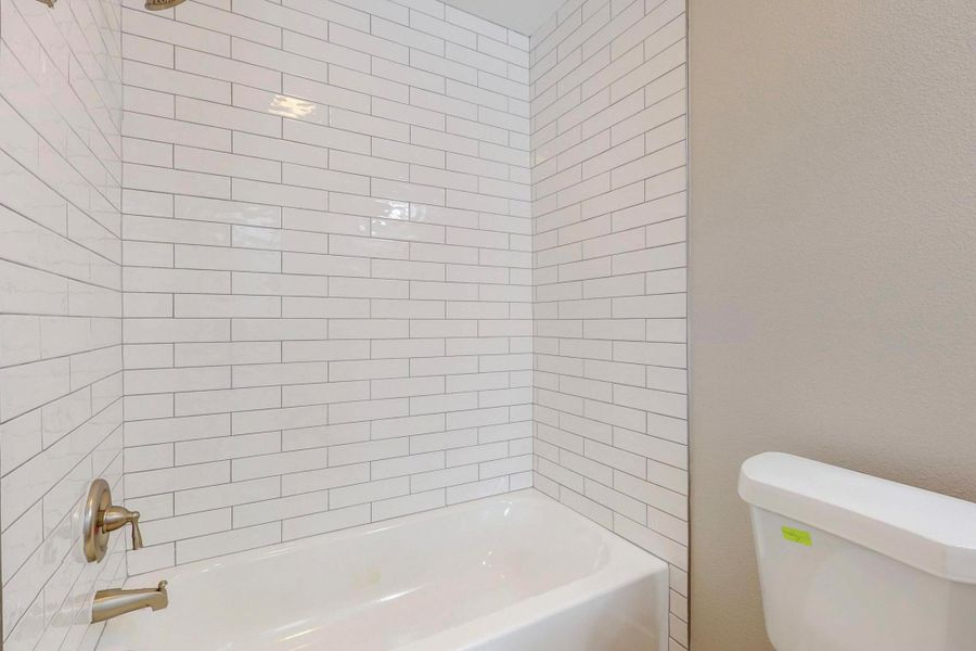 Bathroom featuring toilet and shower / bathing tub combination