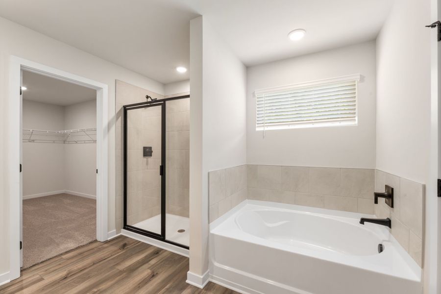A bathroom with a tub and shower. A bathroom with a tub and shower.