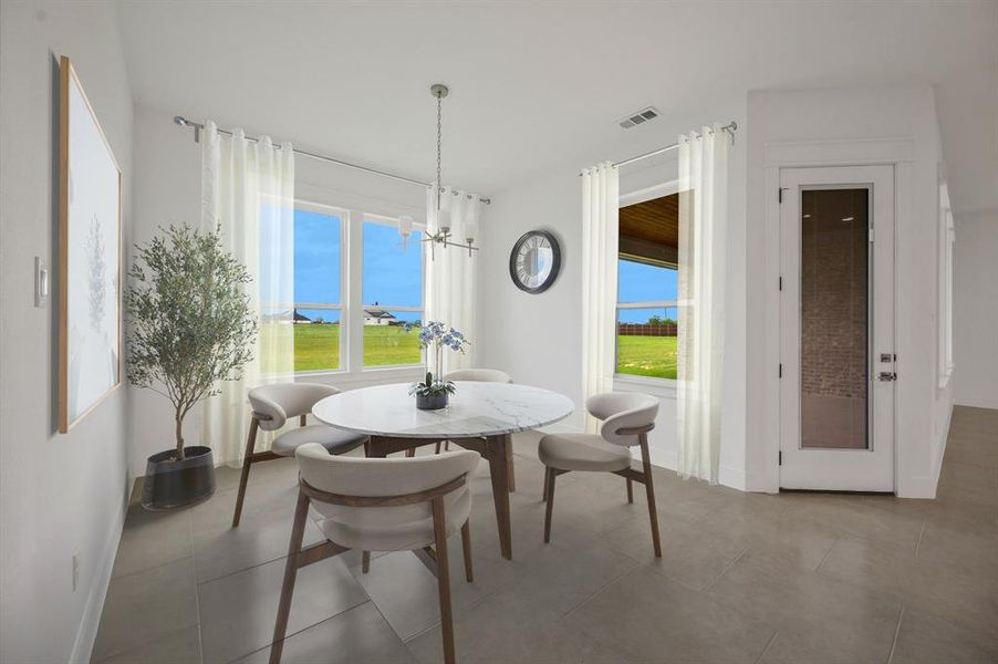 Tiled dining area featuring visible vents, baseboards, and a wealth of natural light Tiled dining area featuring visible vents, baseboards, and a wealth of natural light
