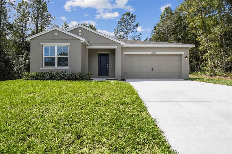 Front exterior of a new home in Aspire at Citrus Springs, Citrus Springs, FL, highlighting curb appeal (Image 1). Front exterior of a new home in Aspire at Citrus Springs, Citrus Springs, FL, highlighting curb appeal (Image 1).