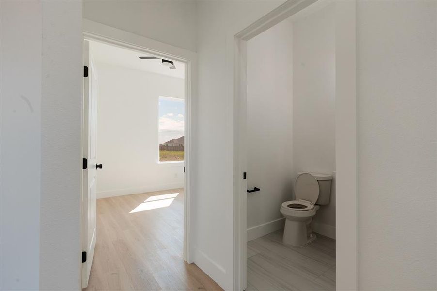 Well-placed hall powder room ideal for guests.