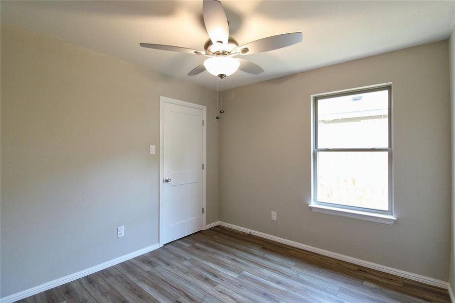 Spare room featuring light wood finished floors and ceiling fan