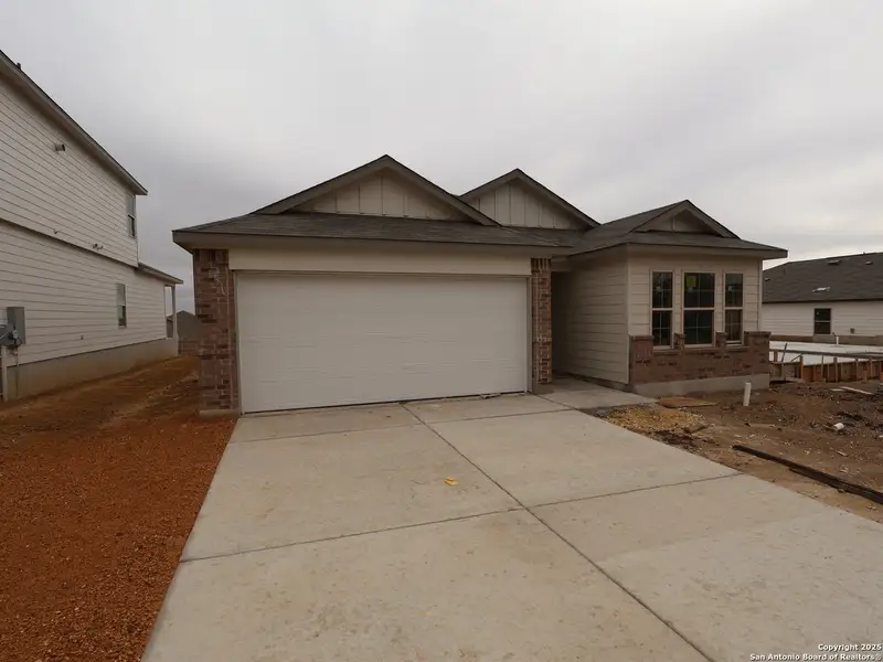 Front exterior of a new home in Hunters Ranch, San Antonio, TX, highlighting curb appeal (Image 1). Front exterior of a new home in Hunters Ranch, San Antonio, TX, highlighting curb appeal (Image 1).