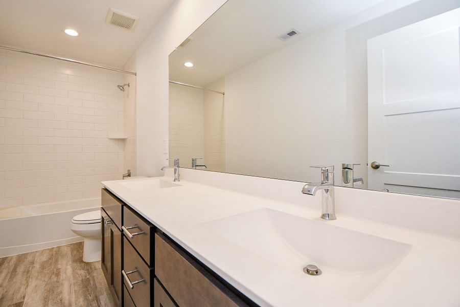 This photo showcases a covered patio with two ceiling fans and a spacious backyard. It's ideal for outdoor entertaining and relaxation, with privacy provided by a wooden and wrought iron fence and a view of trees beyond. This photo showcases a covered patio with two ceiling fans and a spacious backyard. It's ideal for outdoor entertaining and relaxation, with privacy provided by a wooden and wrought iron fence and a view of trees beyond.