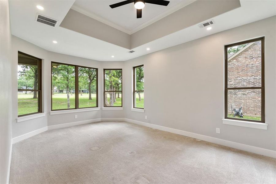 Primary bedroom with bay windows and views of the 17th fairway Primary bedroom with bay windows and views of the 17th fairway